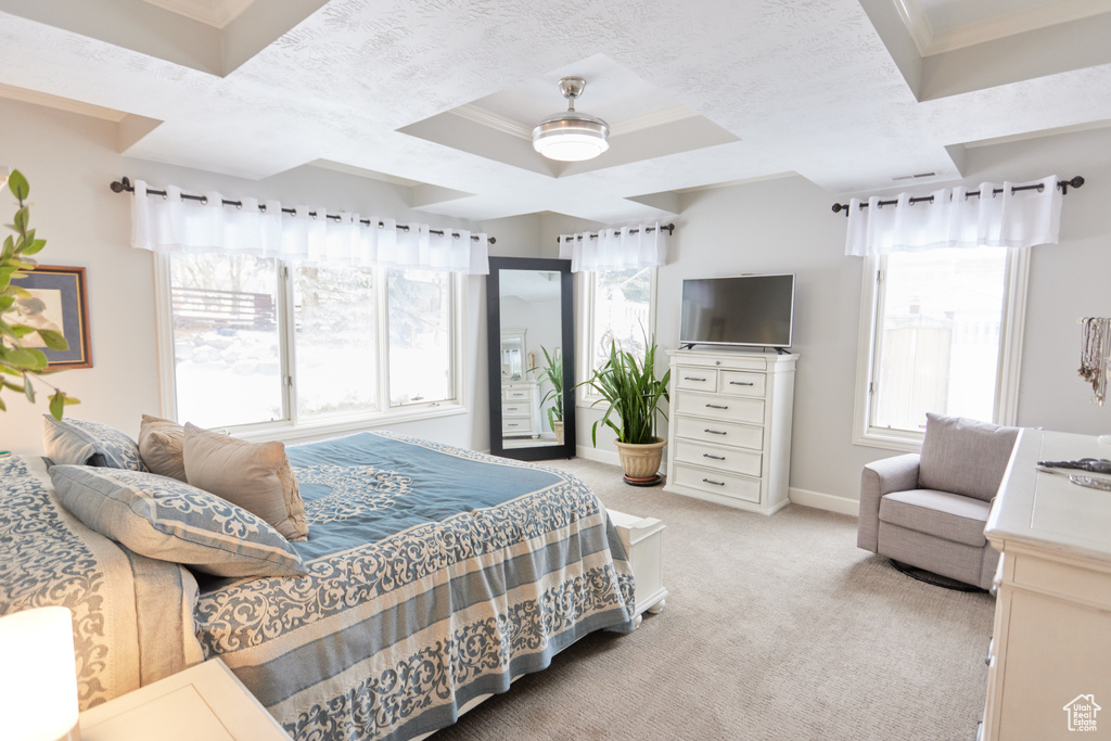 Bedroom with crown molding, light carpet, and a ceiling fan