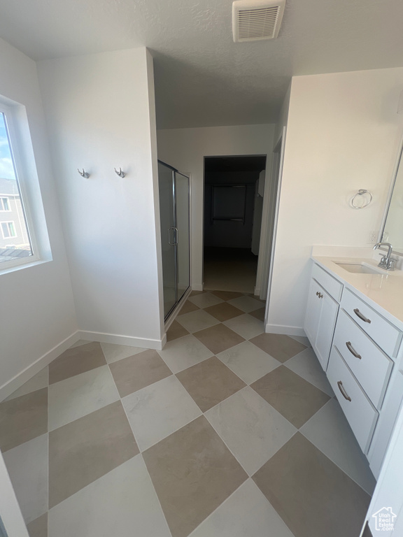 Bathroom featuring vanity and a stall shower