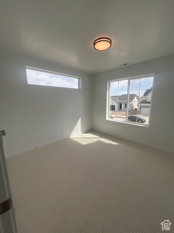 Unfurnished room featuring carpet floors and baseboards