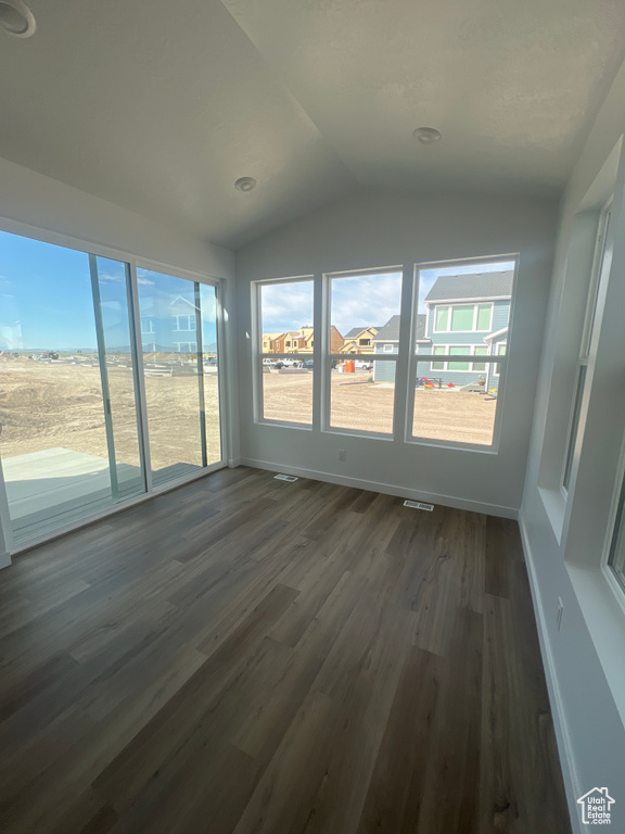 Unfurnished sunroom with vaulted ceiling and healthy amount of natural light