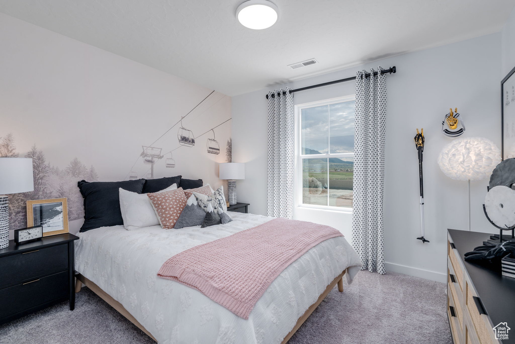 Bedroom featuring light colored carpet and baseboards