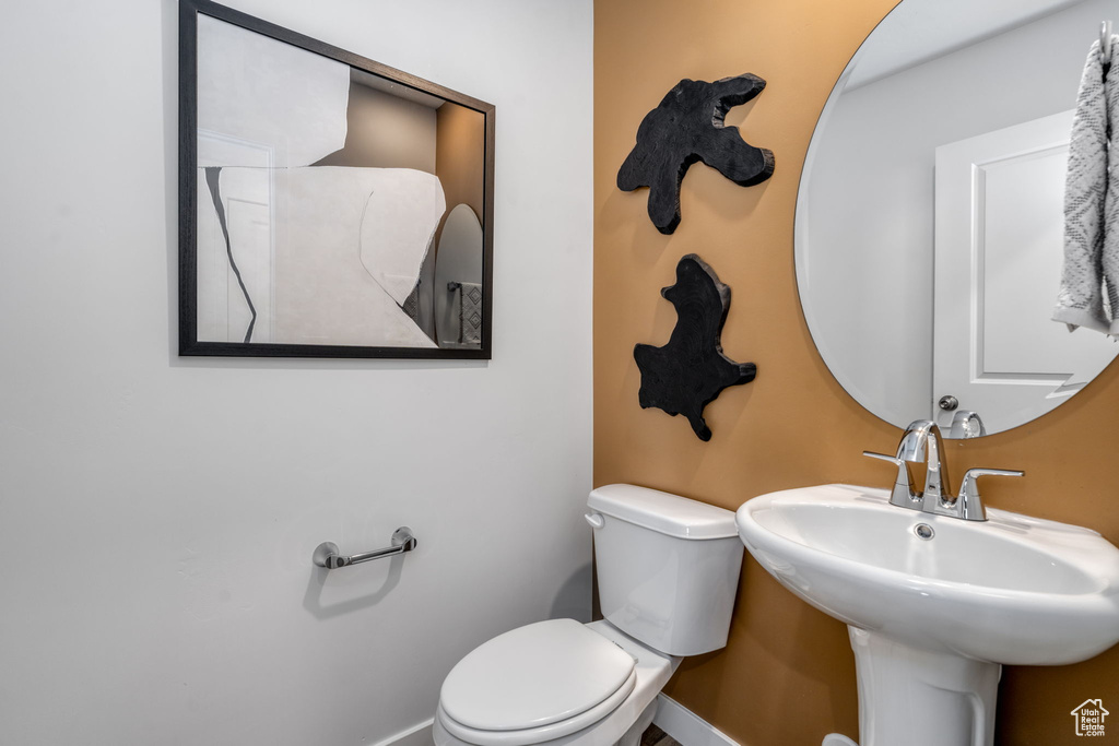 Bathroom featuring baseboards and toilet
