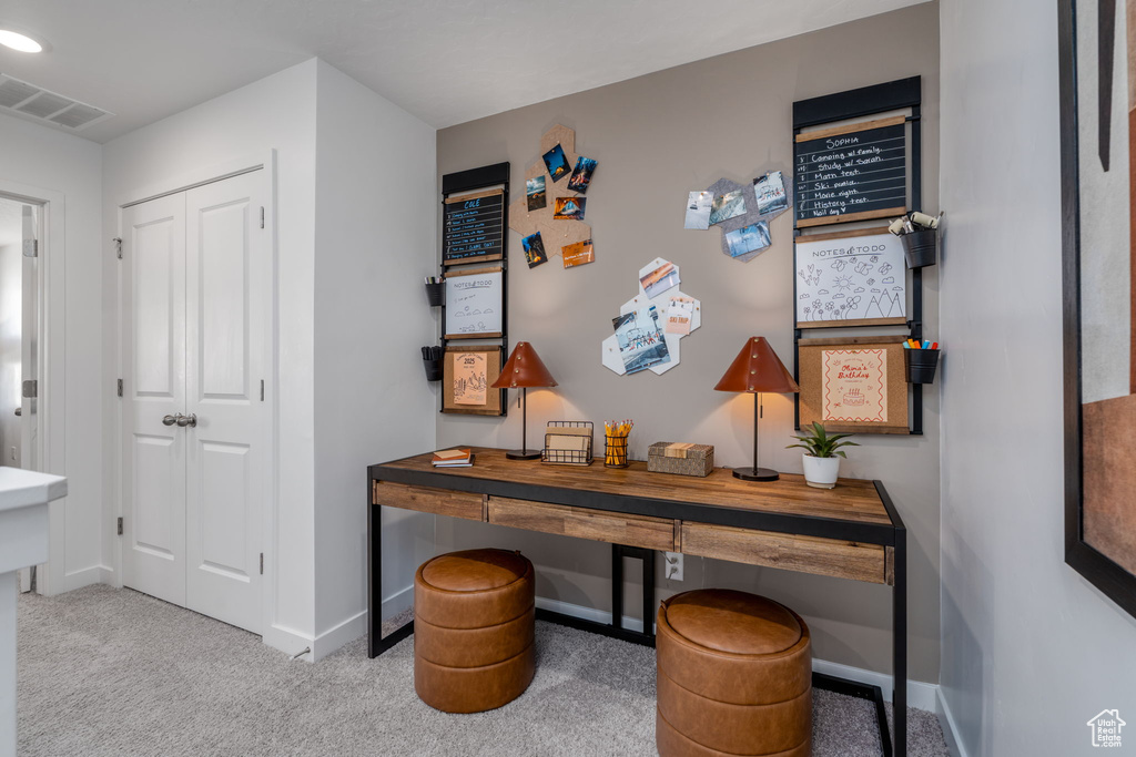 Carpeted home office with baseboards