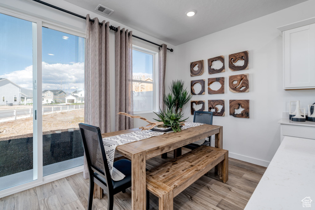 Dining space featuring light wood-style floors and recessed lighting