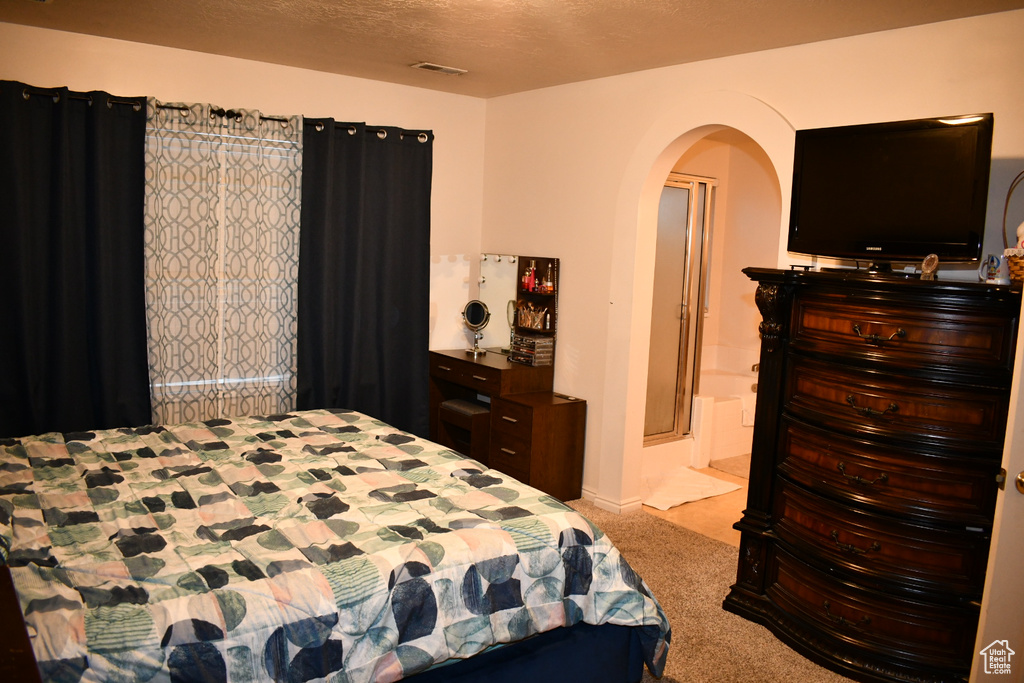 Bedroom with carpet and arched walkways