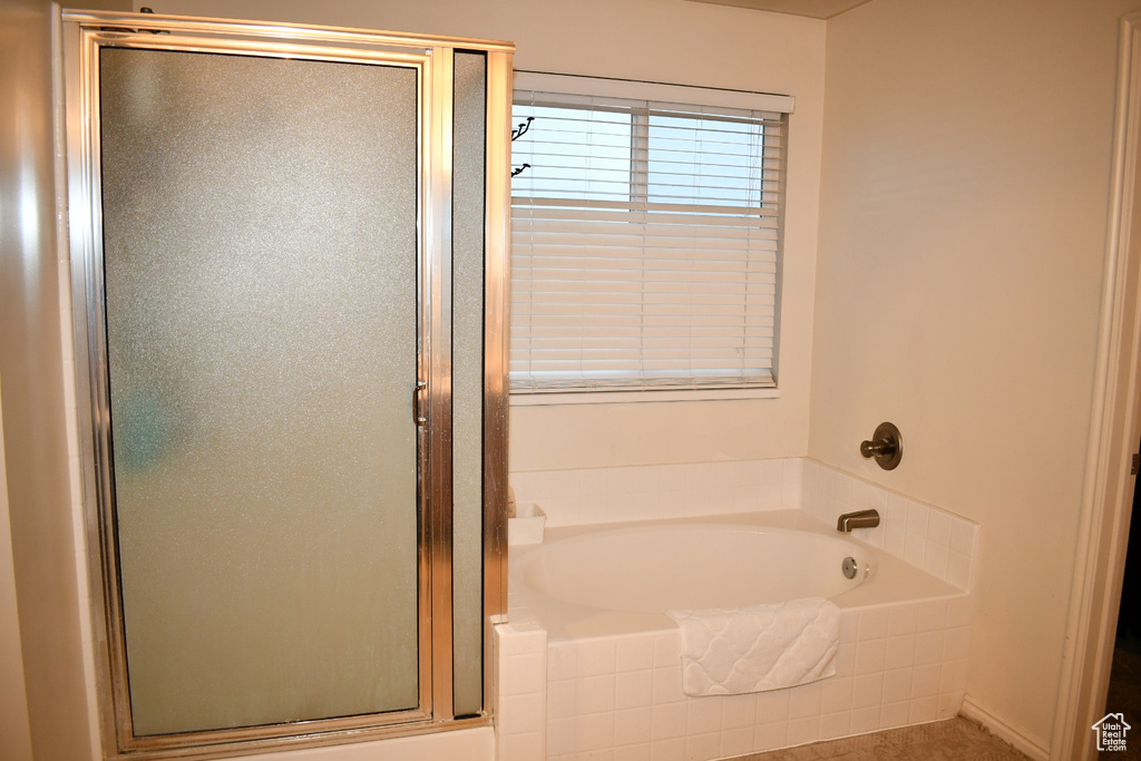 Bathroom with a stall shower and a bath