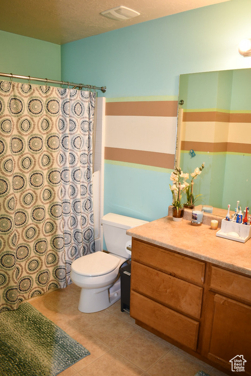 Full bath with vanity, tile patterned flooring, and curtained shower