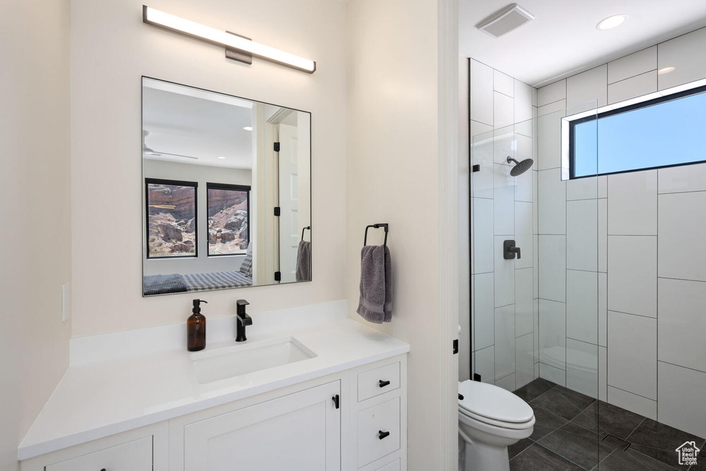 Bathroom with vanity, a walk in shower, recessed lighting, and tile patterned flooring