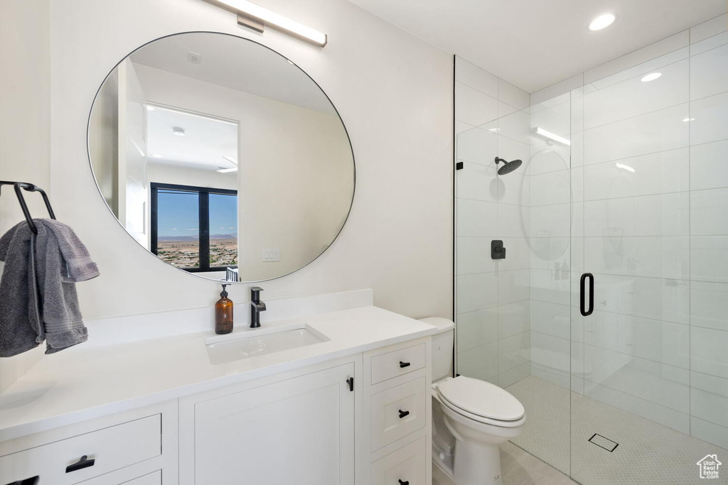 Full bathroom with a shower stall, vanity, and recessed lighting