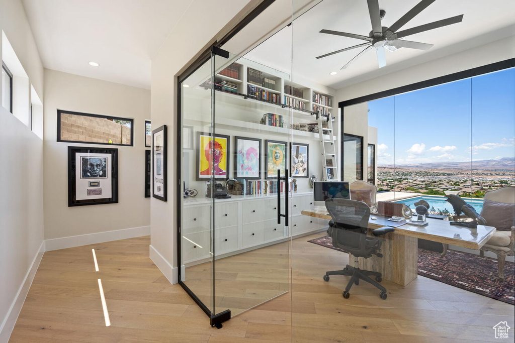 Office with wood finished floors, ceiling fan, and recessed lighting