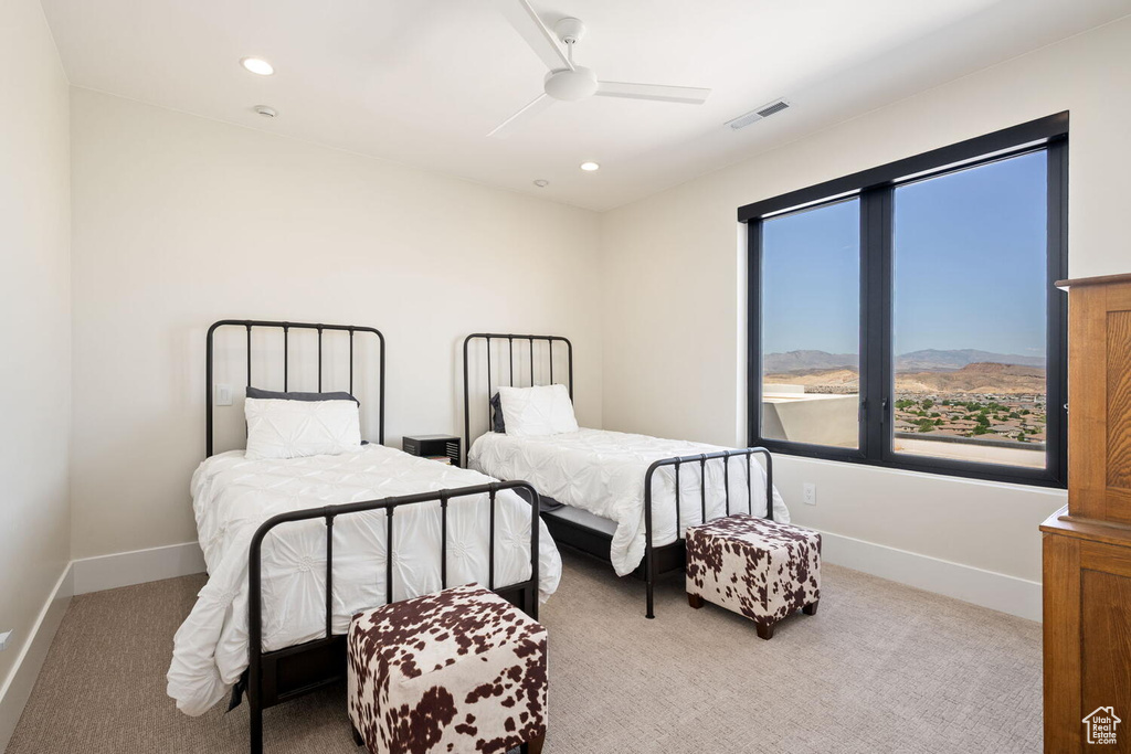 Carpeted bedroom featuring a ceiling fan and recessed lighting