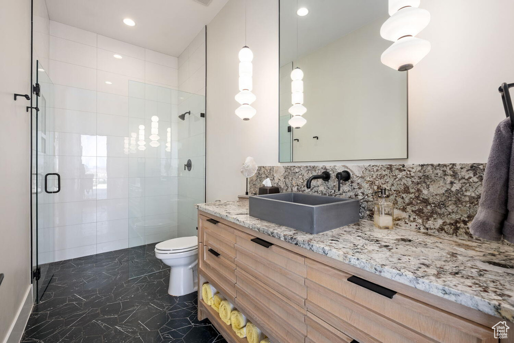 Bathroom featuring a shower stall, vanity, and recessed lighting