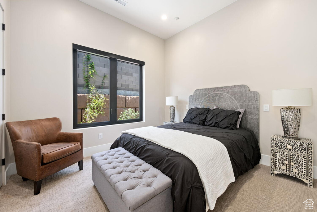 Bedroom with light colored carpet and recessed lighting