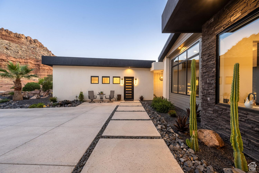 Property entrance featuring a patio and stucco siding