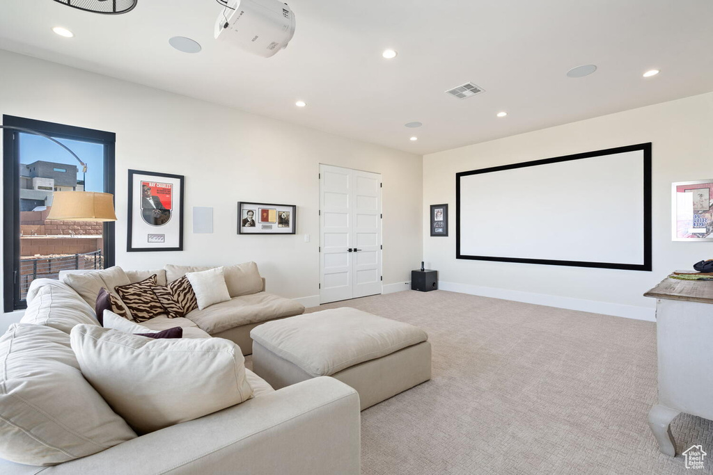 Cinema room with recessed lighting and light carpet