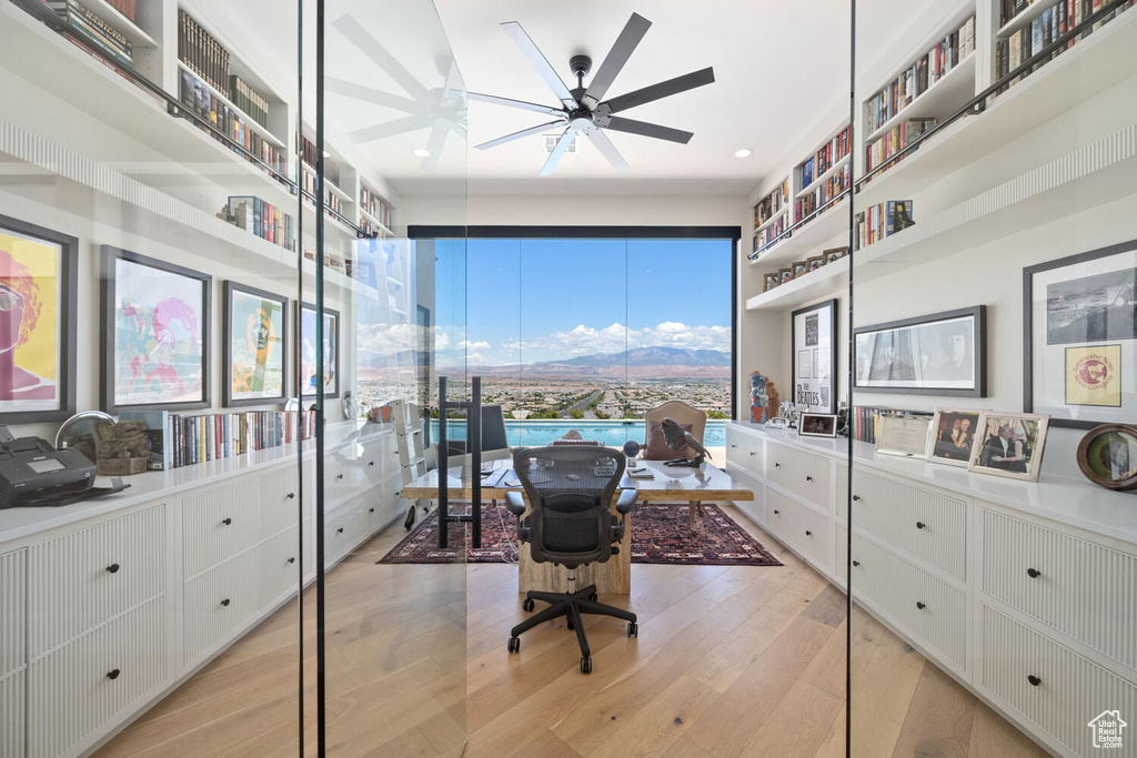 Office area featuring light wood-style flooring, a ceiling fan, recessed lighting, and a mountain view