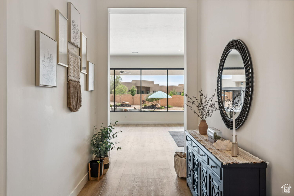 Hall with wood finished floors and baseboards