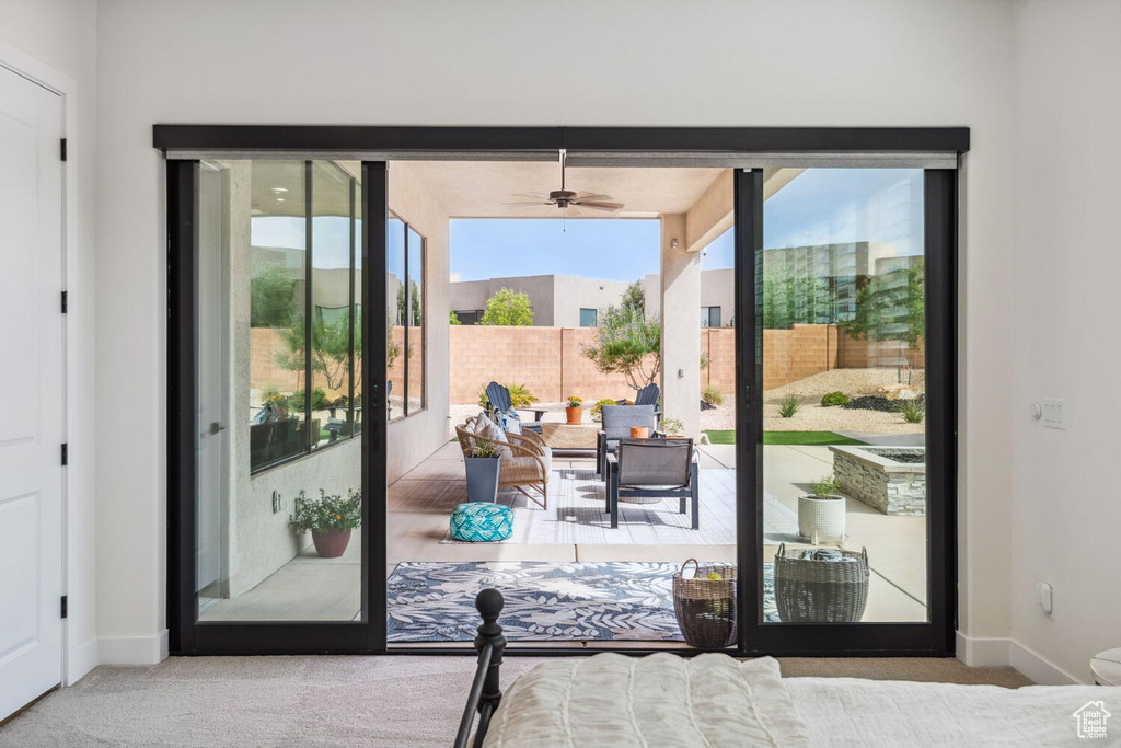 Entryway featuring carpet and ceiling fan