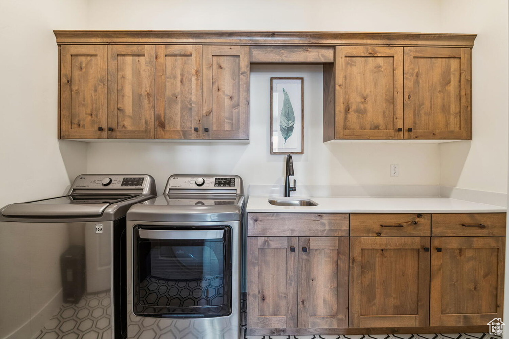Laundry room featuring separate washer and dryer and cabinet space