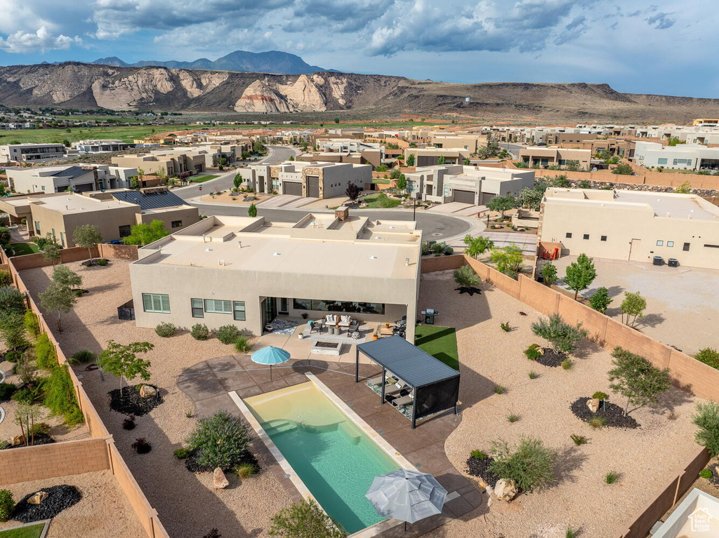 Aerial perspective of suburban area with a mountainous background and a pool area