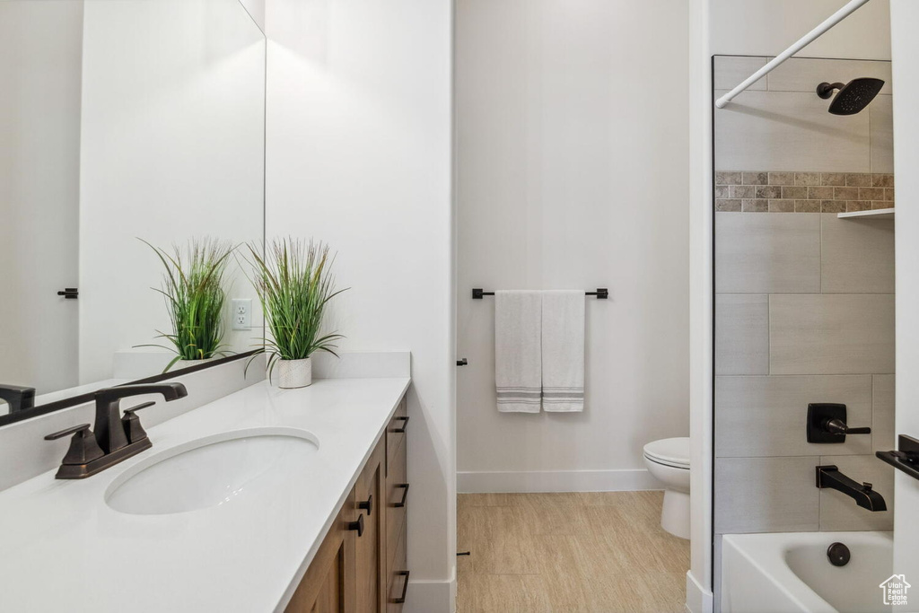 Bathroom featuring vanity and washtub / shower combination