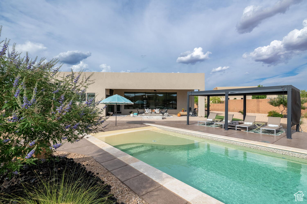 Outdoor pool featuring a patio and a ceiling fan