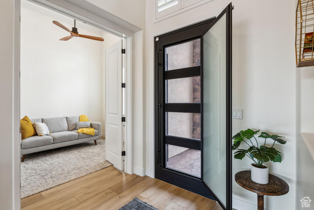 Entrance foyer with wood finished floors and ceiling fan