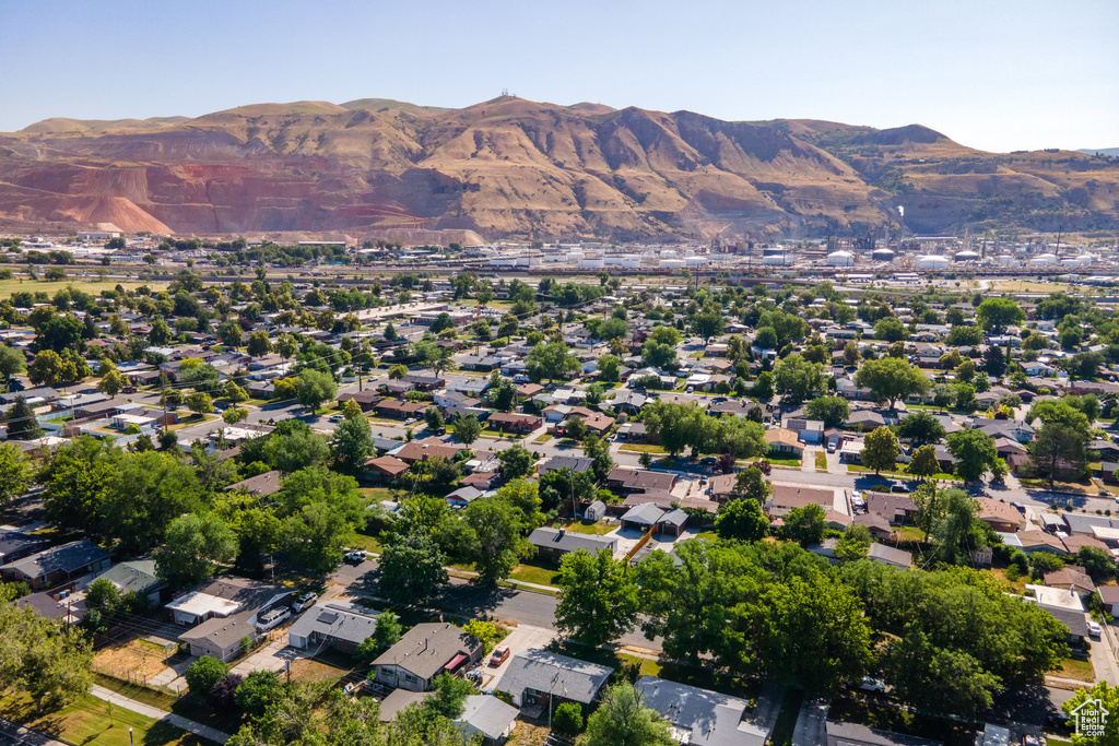 Aerial view of property's location with mountains and nearby suburban area