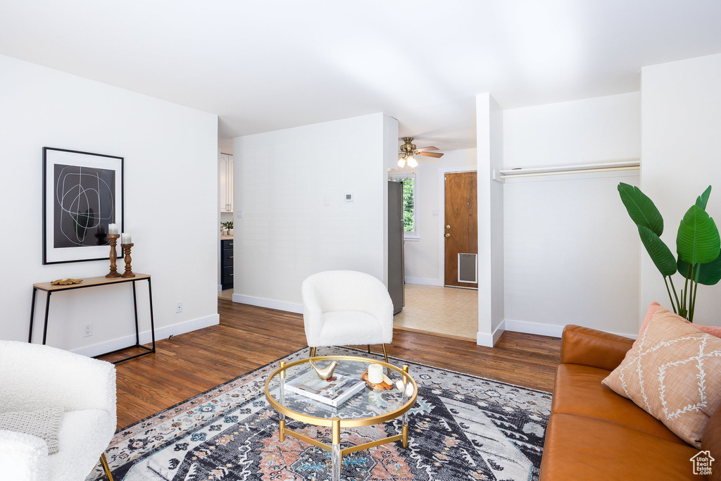 Living room with wood finished floors and ceiling fan