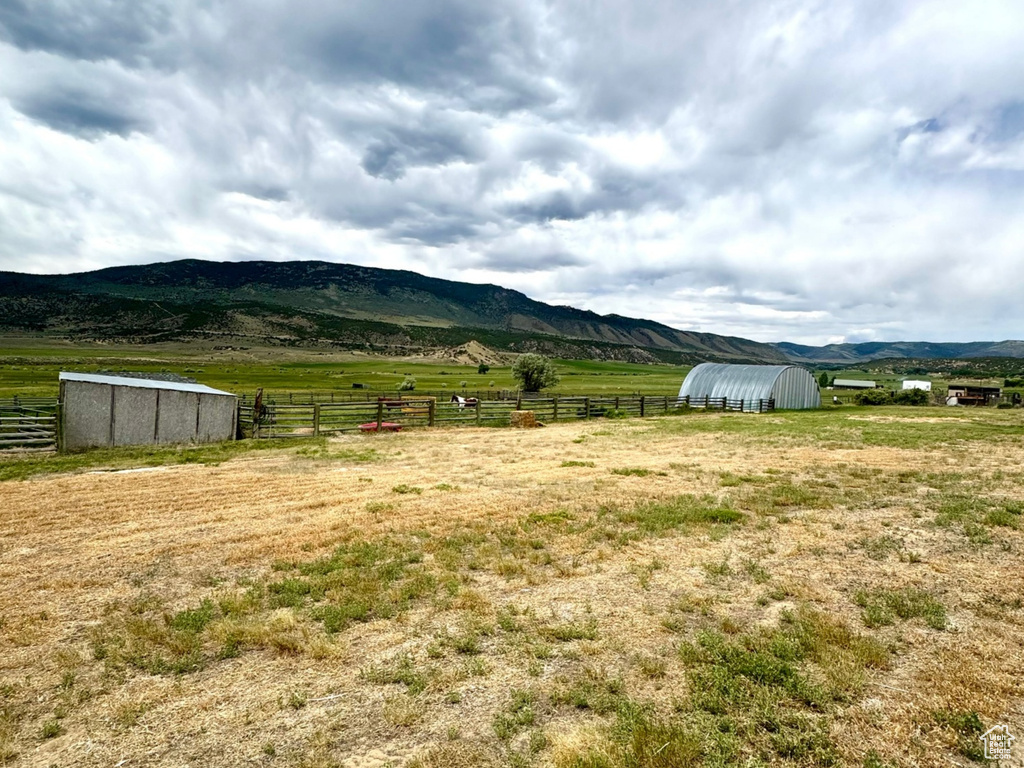 View of mountain backdrop with rural landscape