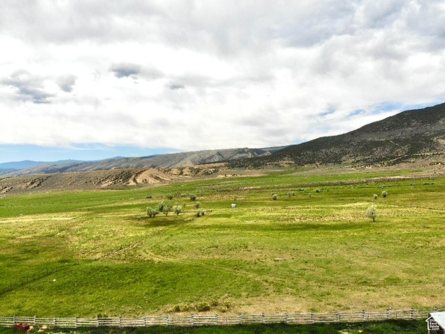 View of mountain backdrop with rural landscape