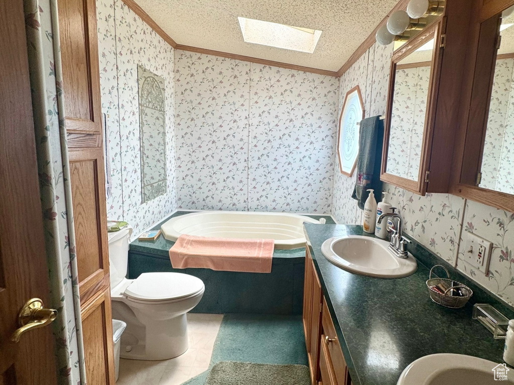 Full bathroom featuring wallpapered walls, ornamental molding, a skylight, a garden tub, and a textured ceiling