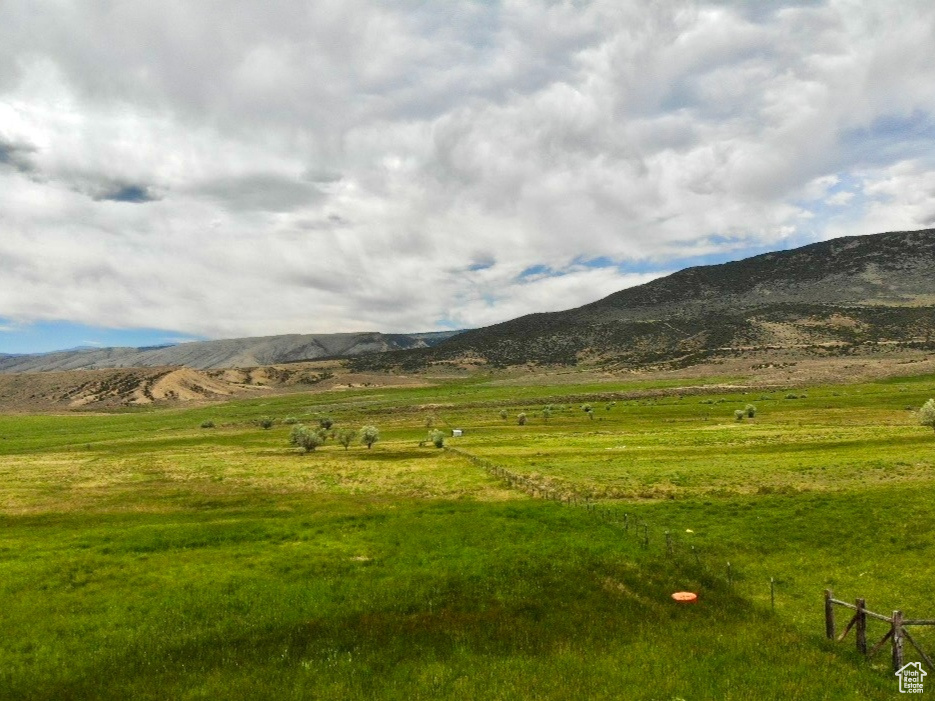 View of mountain backdrop with rural landscape