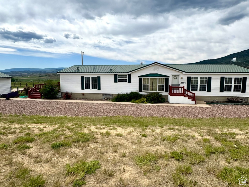 Rear view of property featuring a metal roof