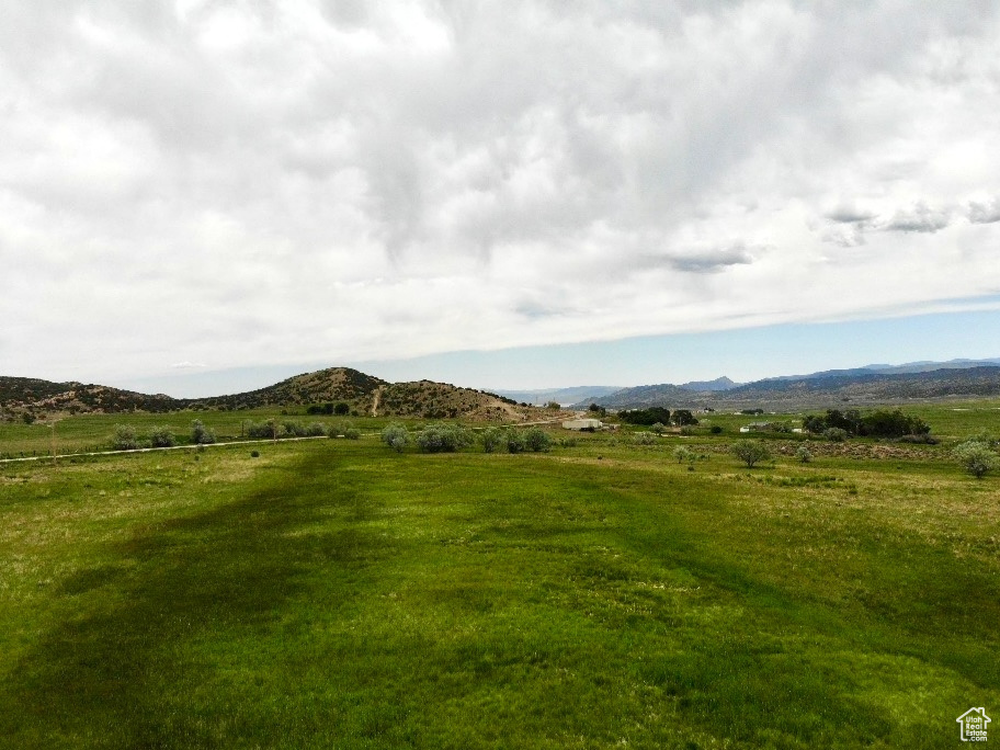 View of mountain backdrop with rural landscape