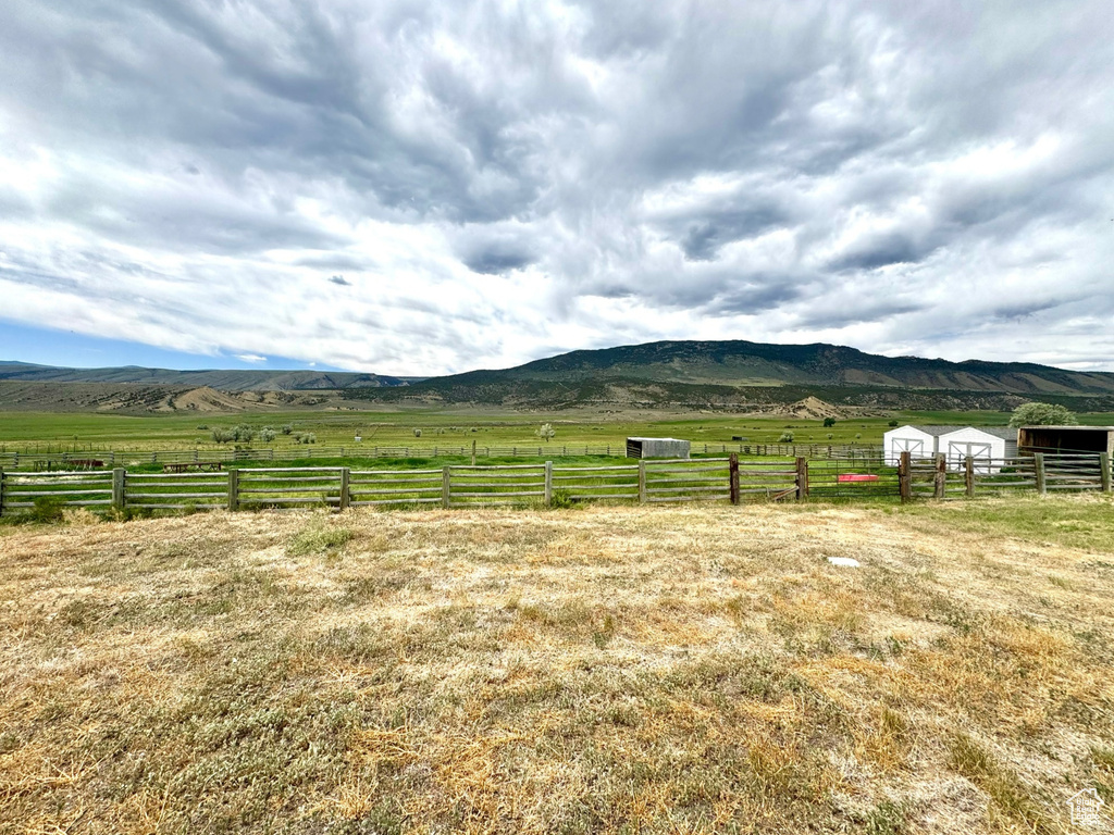 View of mountain background with rural landscape and agricultural land