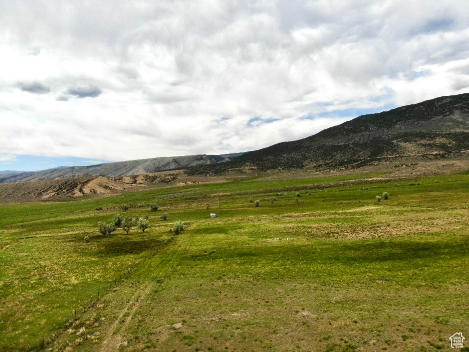 View of mountain backdrop with rural landscape