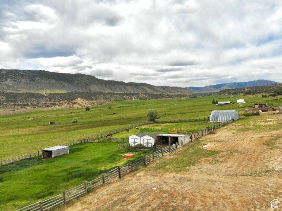 View of mountain backdrop with rural landscape and a pastoral area