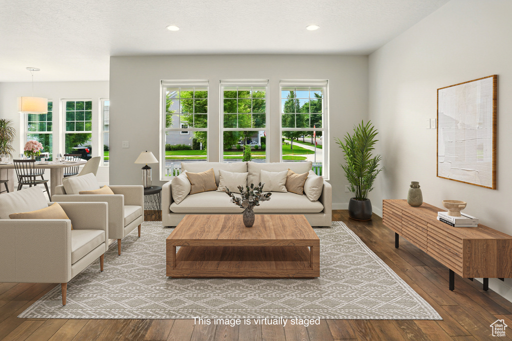 Living area featuring wood-type flooring and recessed lighting
