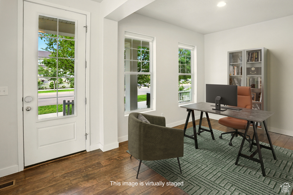 Home office with wood-type flooring