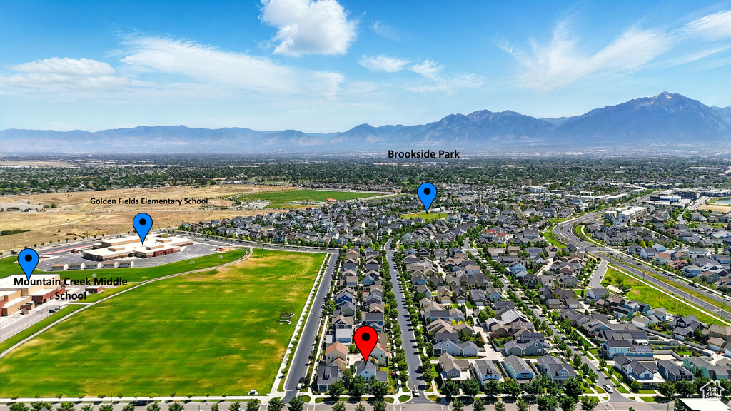 Aerial view of residential area featuring a mountain backdrop