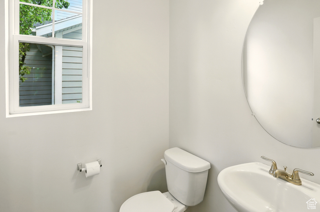 Half bath with a sink and toilet