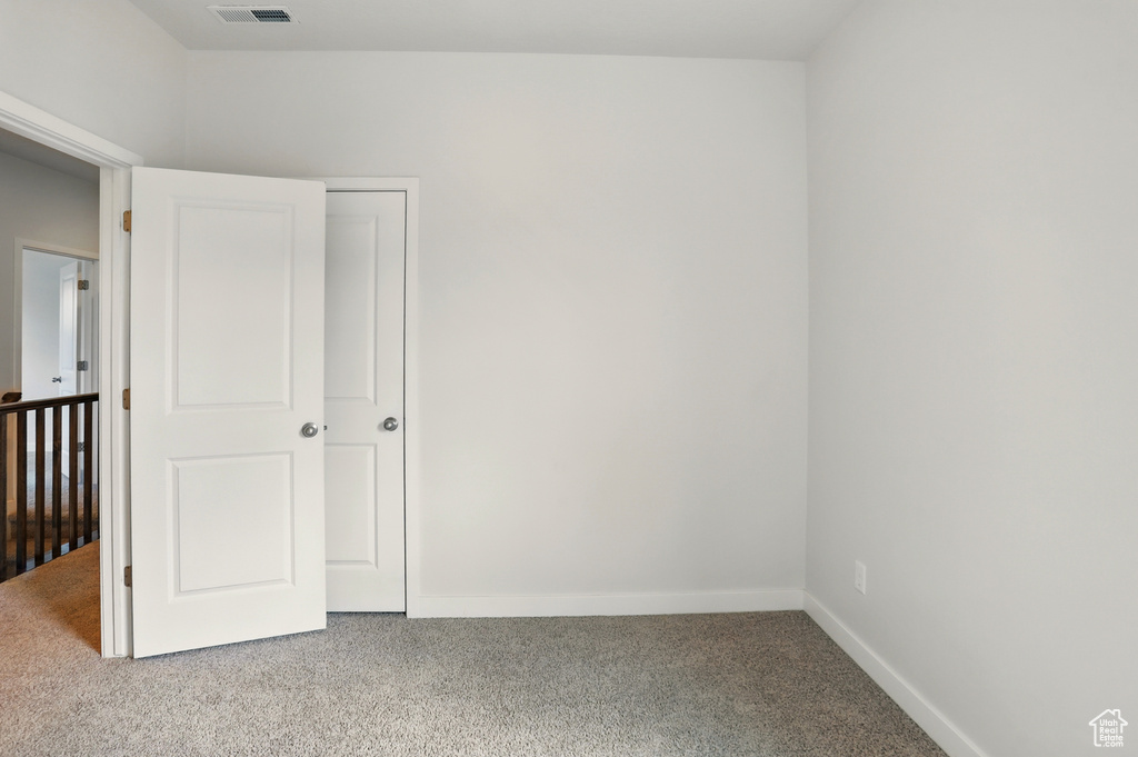 Unfurnished bedroom featuring carpet flooring and baseboards