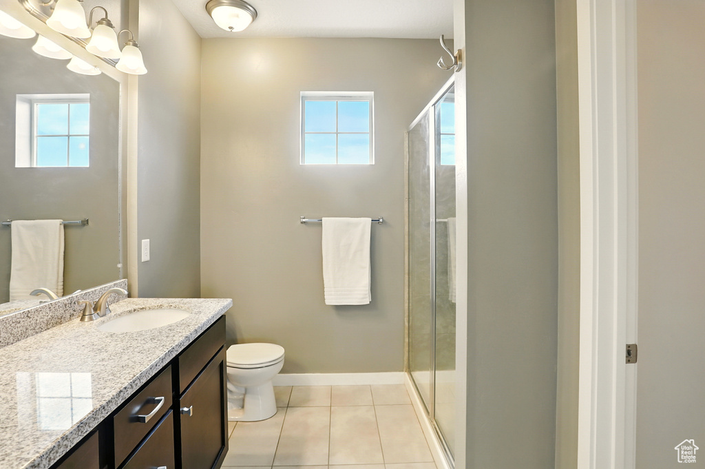 Bathroom featuring vanity, a stall shower, and healthy amount of natural light