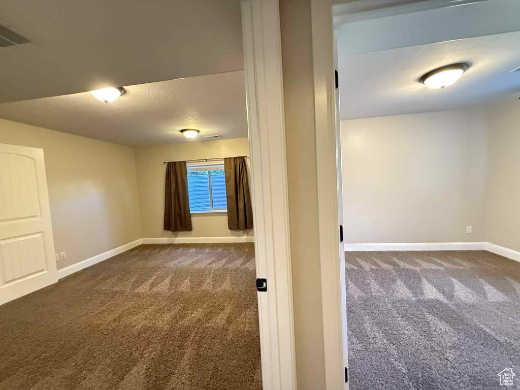 Unfurnished room with carpet