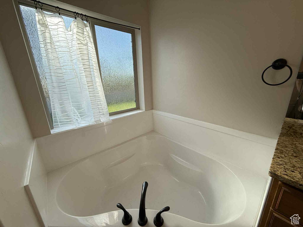 Full bathroom featuring a bath and vanity