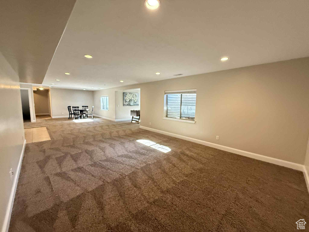 Below grade area with recessed lighting, carpet flooring, and plenty of natural light