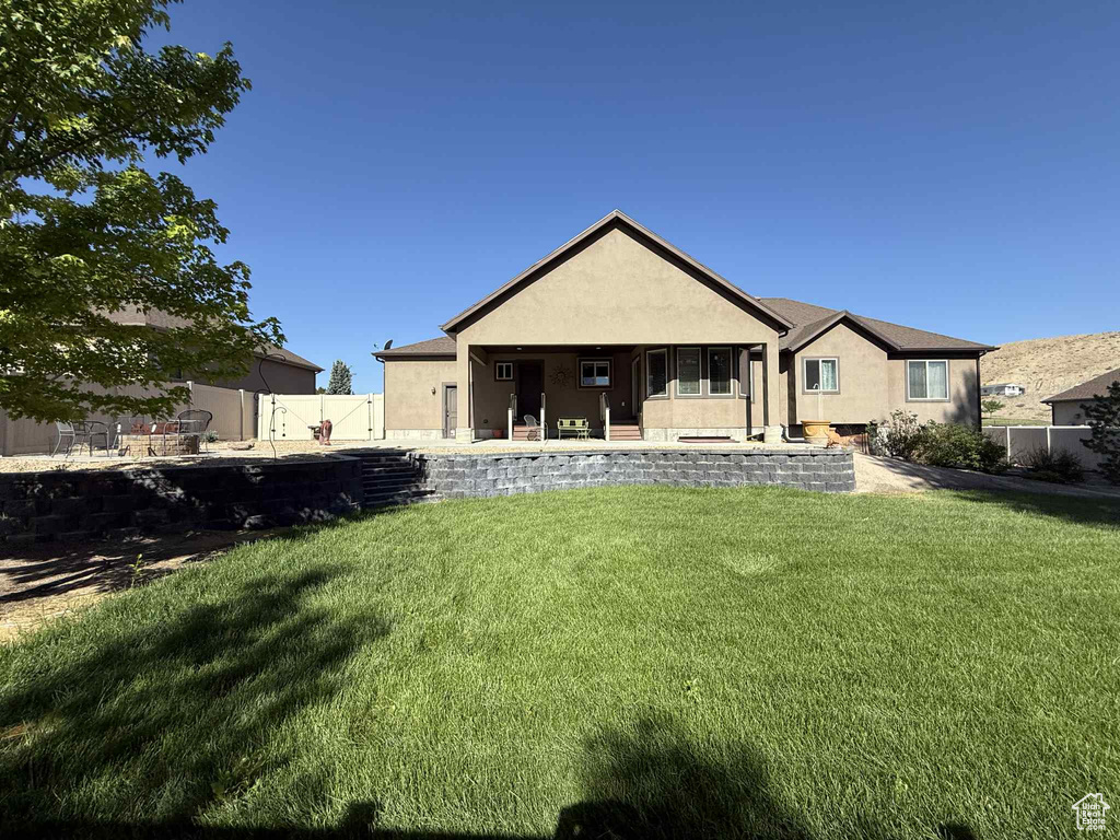 Back of house featuring stucco siding