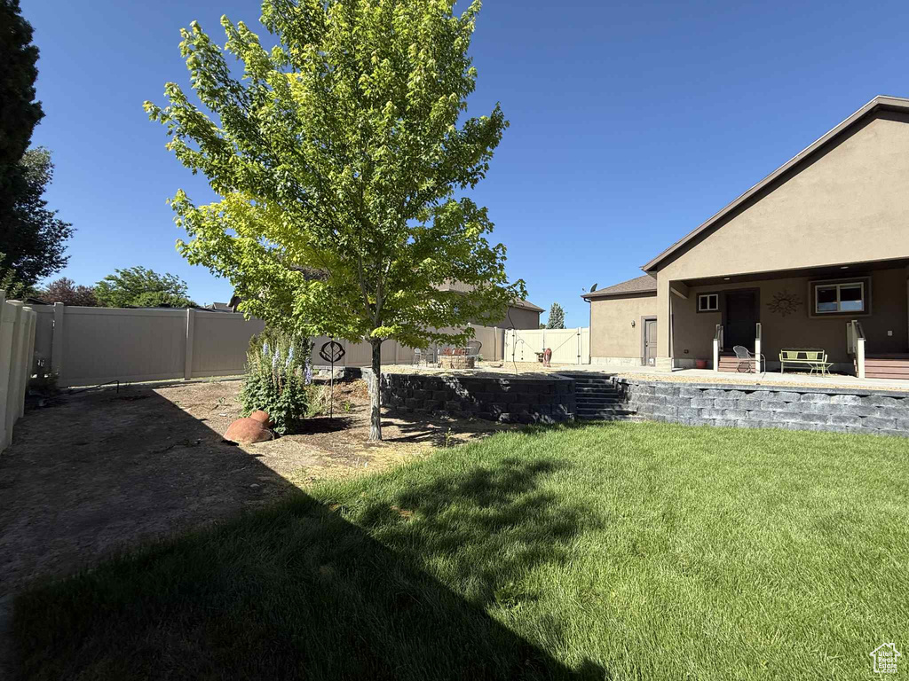Fenced backyard featuring a patio