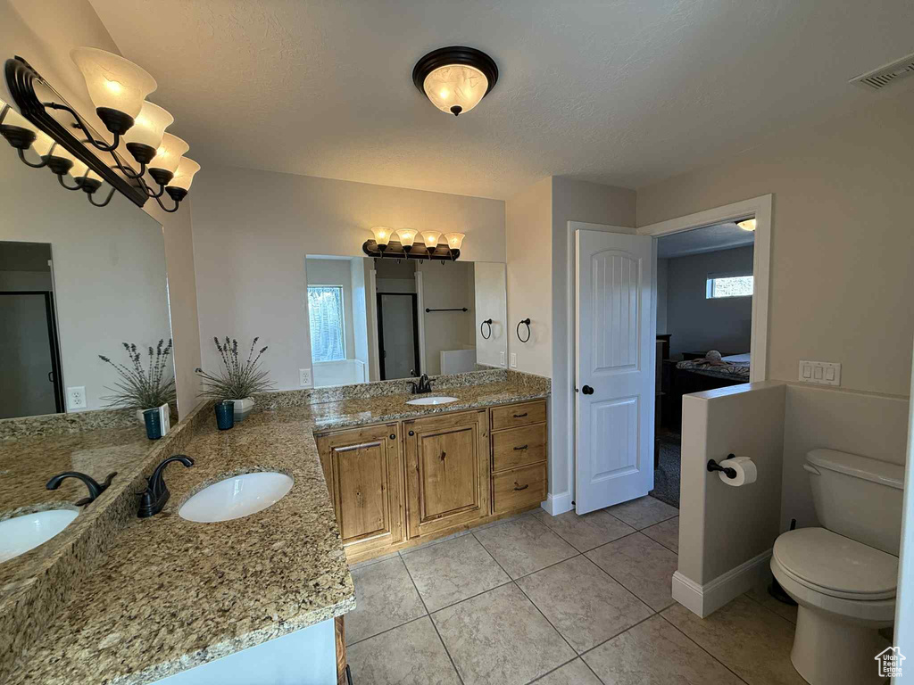 Bathroom with vanity, ensuite bath, tile patterned floors, and plenty of natural light